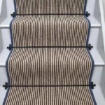 Hardy-striped-wool-stair-runner-with-blue-edging-and-black-stair-rods.-1